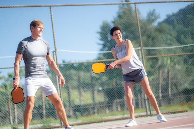 Two pickleball players, a man and a woman