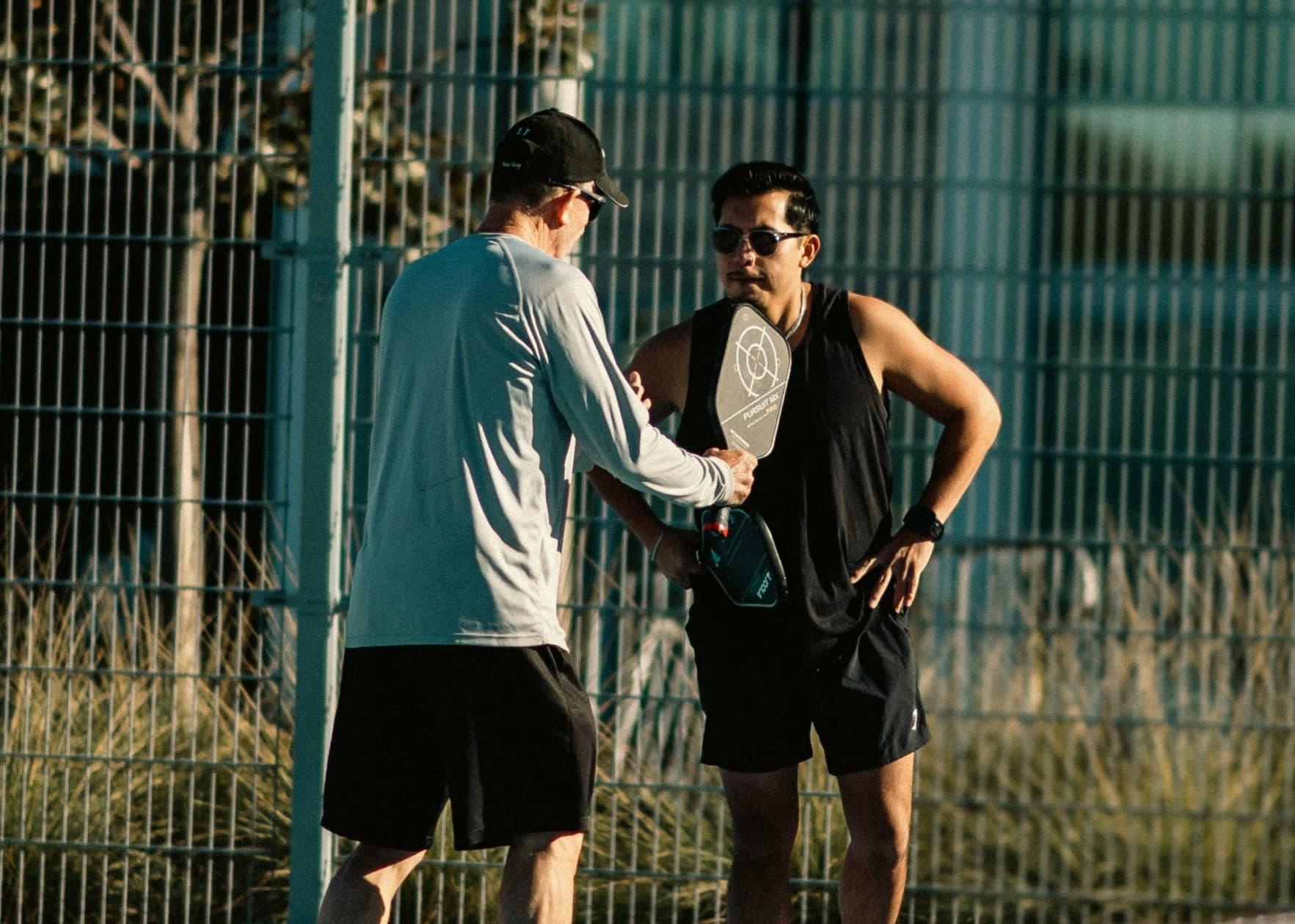High five of two pickleball players